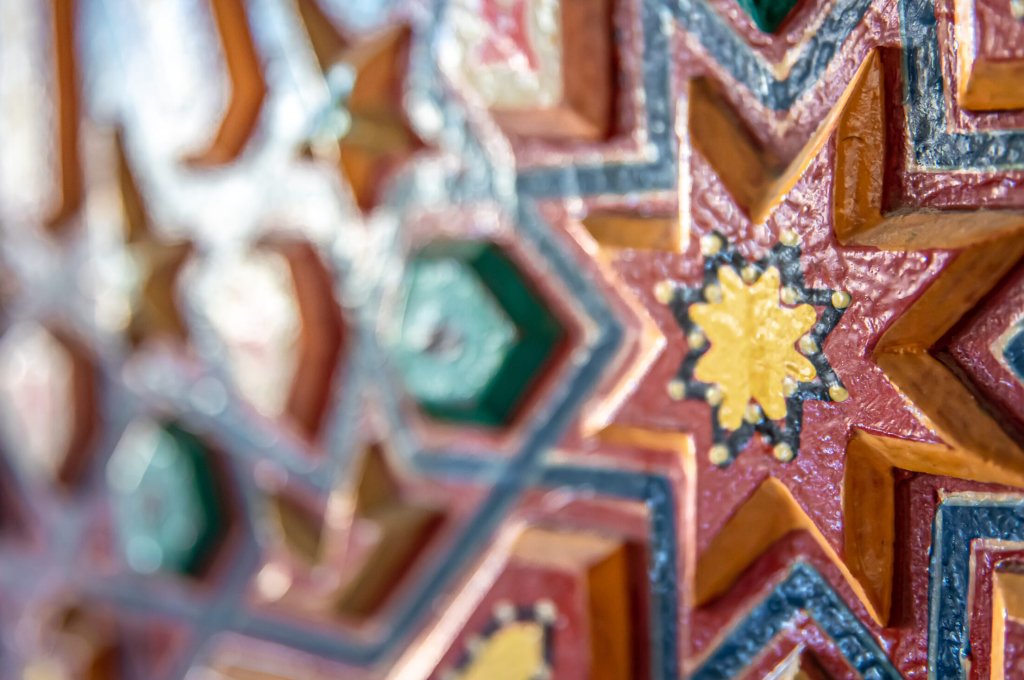 Close up of colored ornament on wood in traditional oriental style.